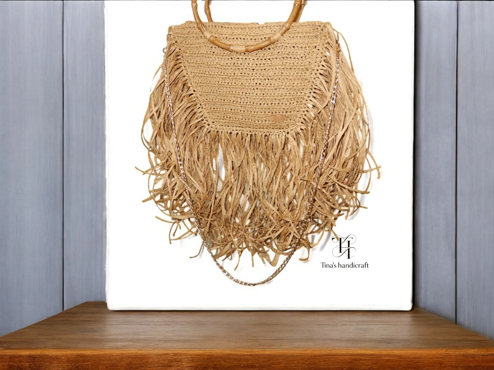 Handmade straw bag with long fringes.