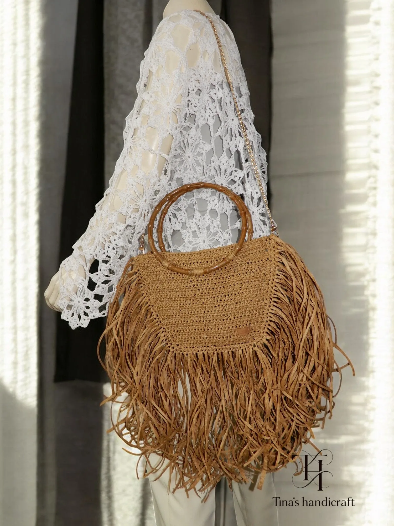 Handmade straw bag with long fringes.